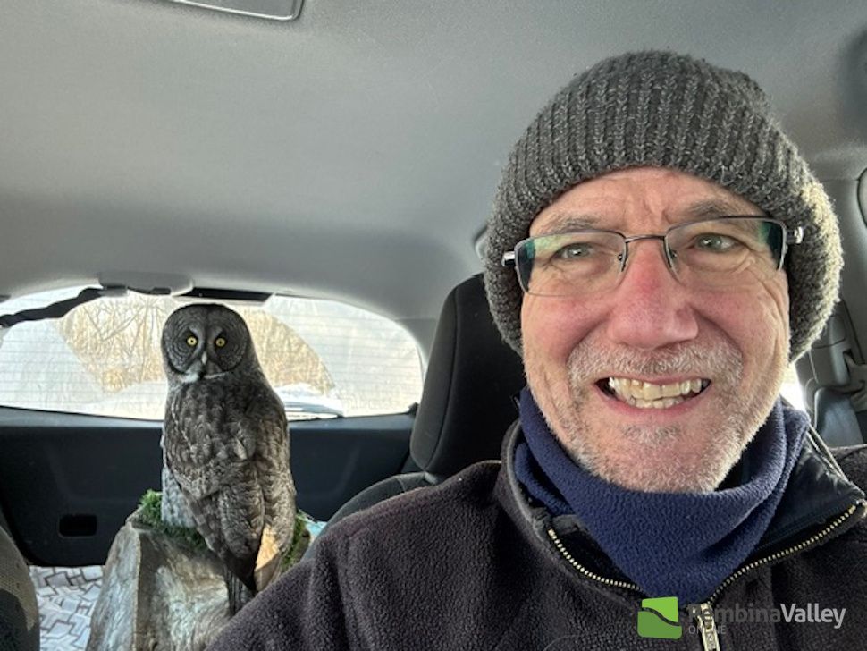 Biologist Jim Duncan with an owl in the backseat